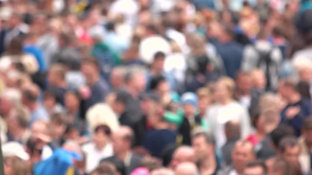 Blurred crowd of people at the stadium. Background of defocused and blurred crowd of people walking on busy street.