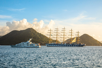 Fototapeta na wymiar Motor yacht and big naval clipper anchored at the Rodney bay with , Rodney bay, Saint Lucia, Caribbean sea