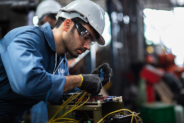 Engineer manual workers standing in a aluminum mill and working together. used professional...