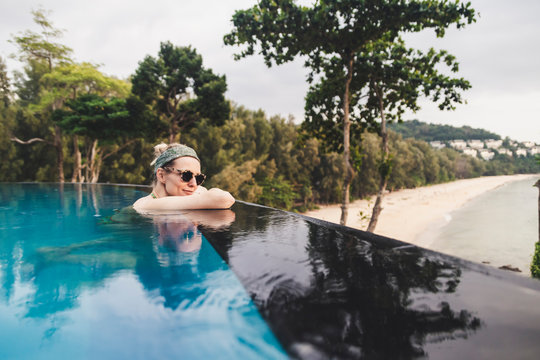 Woman relaxing in infinity pool, Nai Thon Beach, Phuket, Thailand