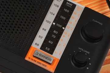 Fototapeta premium Vintage radio for listening to radio programs on a wooden background