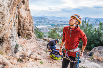 Female climber preparing looking up rock face