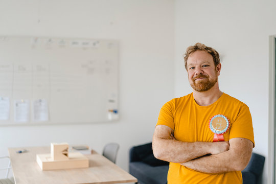 Portrait Of A Confident Casual Businessman With An Award In Office