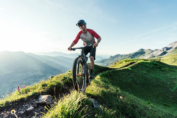 Mountain biker on a way in Grisons, Switzerland