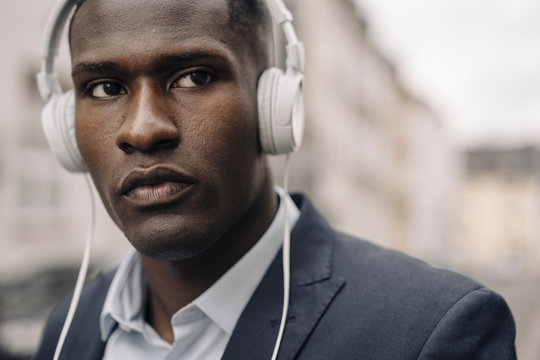 Portrait Of Young Businessman Wearing White Headphones