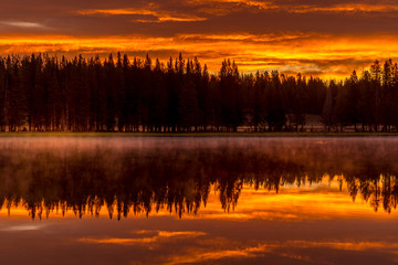 Fototapeta premium Burning sky, sunrise and morning fog at the lake. Yellowstone National Park