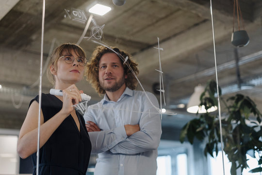 Businessman and businesswoman working on a project in office