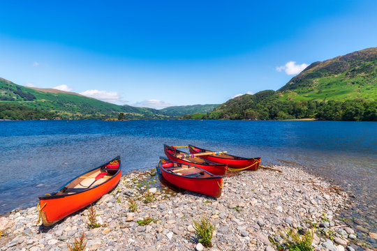 UK, England, Canoes left on shore of Ullswater