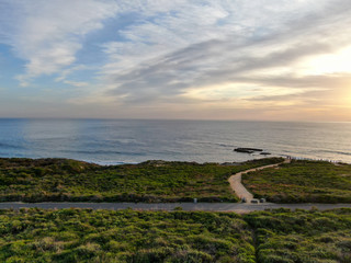 Aerial view of Pacific ocean colorful sunset, facing the sun with reflection on the ocean and deep...