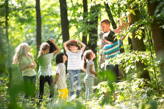 School children fixing a bidhouse on a tree