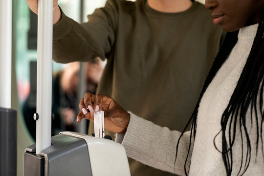 Close-up of woman validating ticket in tramway