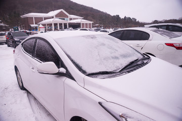 The car's roof is covered with snow white.Extremely cold, winter travel atmosphere, winter travel...