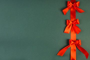 Shiny red satin ribbon on background, place for text, festive concept