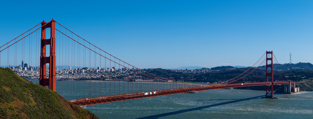 Full view of the Golden Gate Bridge on a clear day in the city by the bay ,skyline in background 