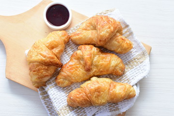 Small butter croissant, accompanied by blackberry jam