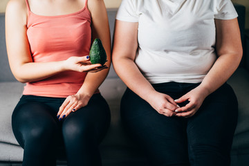 Fit and overweight women with healthy food. Active lifestyle, healthy eating, weight loss, body...