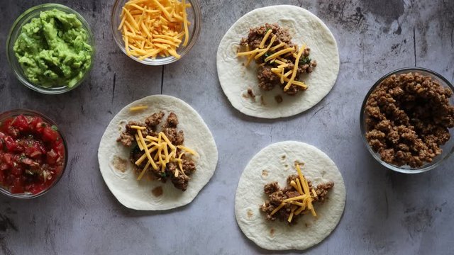 Adding Salsa to Beef Tacos