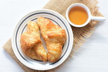 Small butter croissant, accompanied by honey