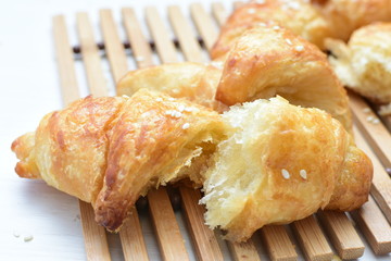 Small butter croissant, accompanied by sesame seeds