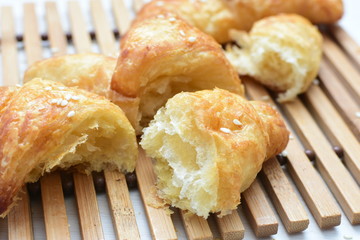 Small butter croissant, accompanied by sesame seeds