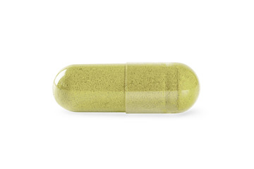 Herbal capsule with green herbal leaves isolated on white background.