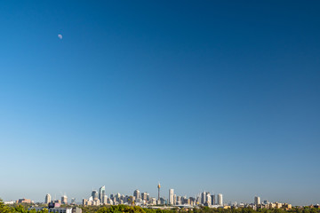 South view of Sydney CBD with plenty of blue sky and the moon
