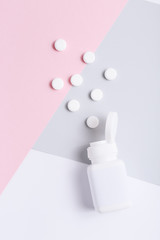 Pharmaceutical medicine pills on colorful background, top view