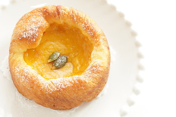 Pumpkin Danish pastry on white background with copy space