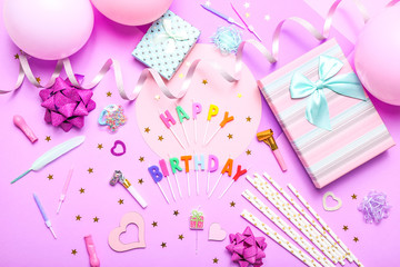 Colorful celebration background with various party confetti, balloons, gifts, and decoration on pink background.