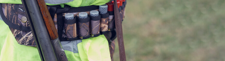 Hunting period, autumn season open. A hunter with a gun in his hands in hunting clothes in the...