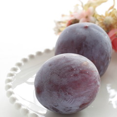 Freshness prune from japan on white dish with copy space