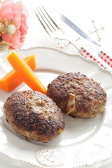 Homemade  hamburger patty and carrot for comfort food
