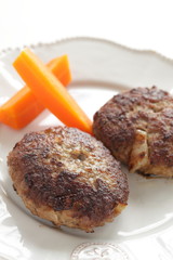 Homemade  hamburger patty and carrot for comfort food