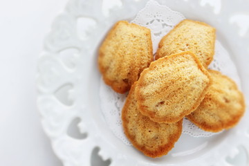 French confectionery, Madeleine cake on dish with copy space 