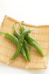 Japanese green pepper on bamboo basket for cooking image
