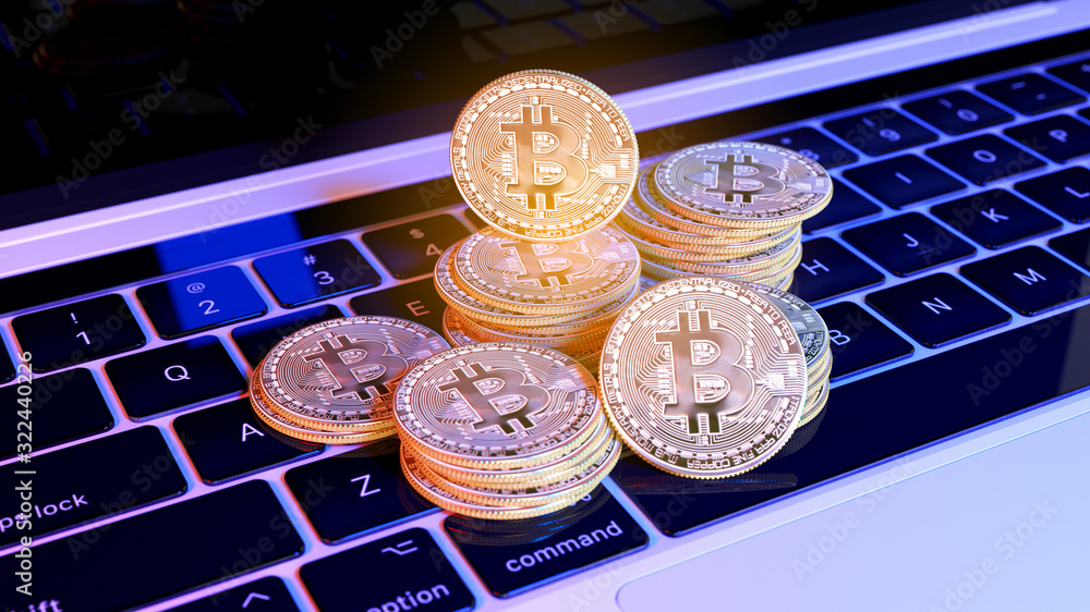 Poster groups of bitcoin with defocused background on the keyboard of laptop. virtual cryptocurrency concep