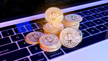 Groups of Bitcoin with defocused background on the keyboard of laptop. Virtual cryptocurrency concept. 3D rendering illustration.