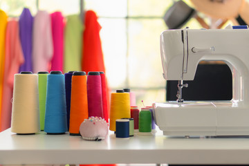 dressmaker shop background of sewing machine with colorful spool of thread