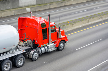 Big rig red semi truck transporting tank semi trailer for carry liquefied gas and other chemicals...