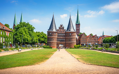 Classic panoramic view of historic city center of Lübeck with famous Holstentor gate on a beautiful sunny day with blue sky and clouds in summer, Schleswig-Holstein, northern Germany