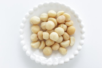 Roasted macadamia nuts on dish with copy space