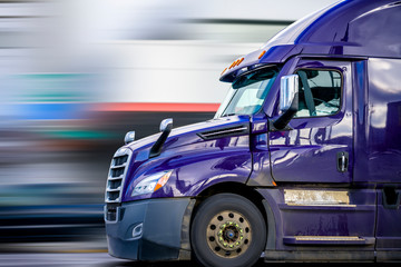 Bright Purple Bonnet Semi Truck Tractor with Reflection Driving on the Road for Delivery Commercial...