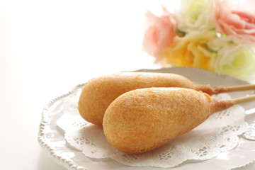 American junk food, corn dog on lace pepper with copy space