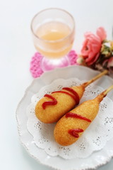 American junk food, corn dog on lace pepper with copy space