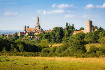 Scenic panoramic view of historic old town of Autun with famous Cathedrale Saint-Lazare d'Autun on top of a hill in beautiful golden evening light at sunset in summer, Saone-et-Loire, Burgundy, France