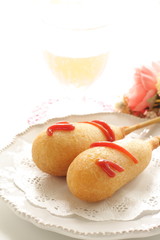 American junk food, corn dog on lace pepper with copy space