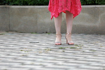 Women's feet in high-heeled sandals