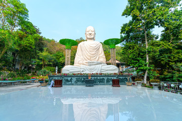 Big buddha statue meditating in front of temple yard near Vung Tau, Vietnam. This is a place where spirituality prays for everyone to lead a peaceful life