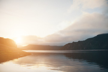 the concept of boating, recreation, travel - splashes of blue water in the river, mountains, sky. Copy space