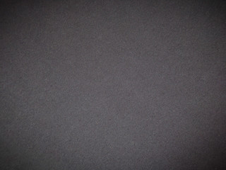 Dark background. Abstract background made of dark fabric. Template for copying space. Background with vignette.